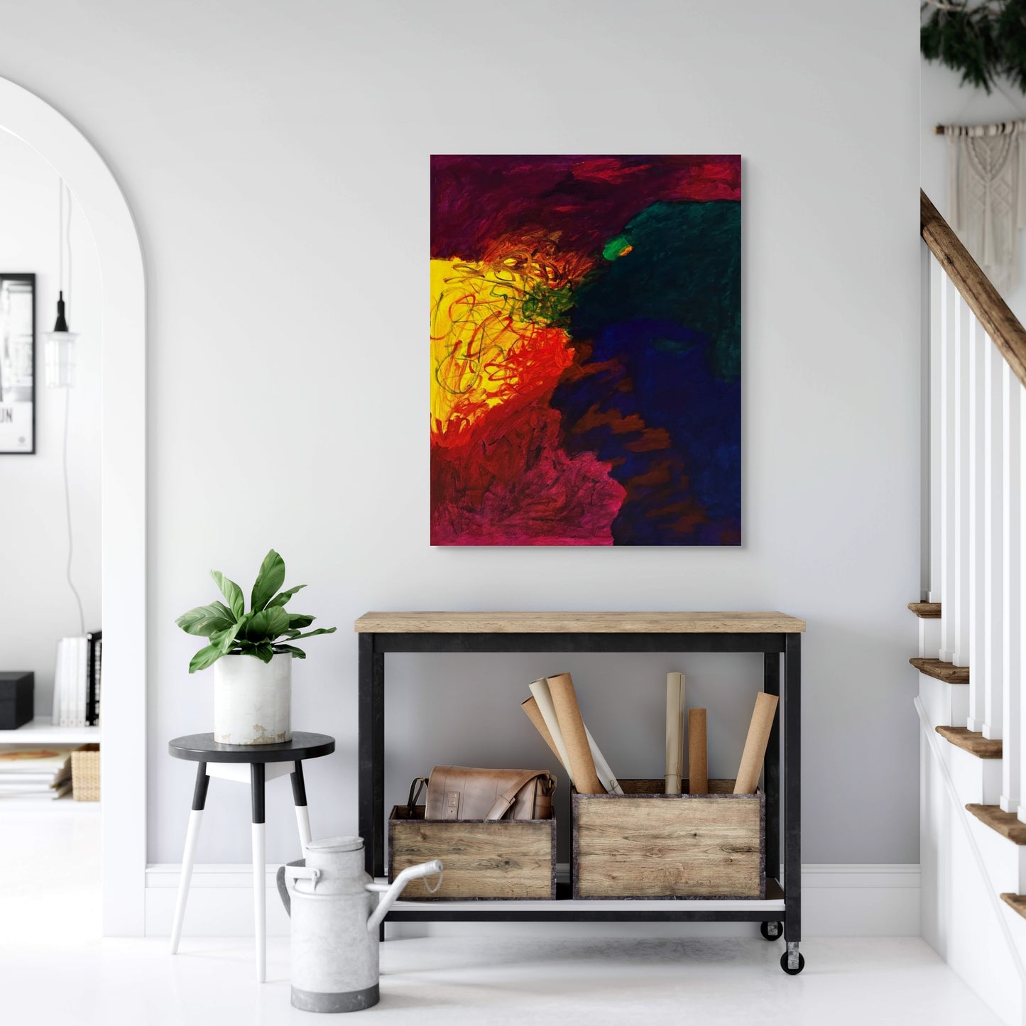 Colorful abstract painting on a white wall above a wooden console table.