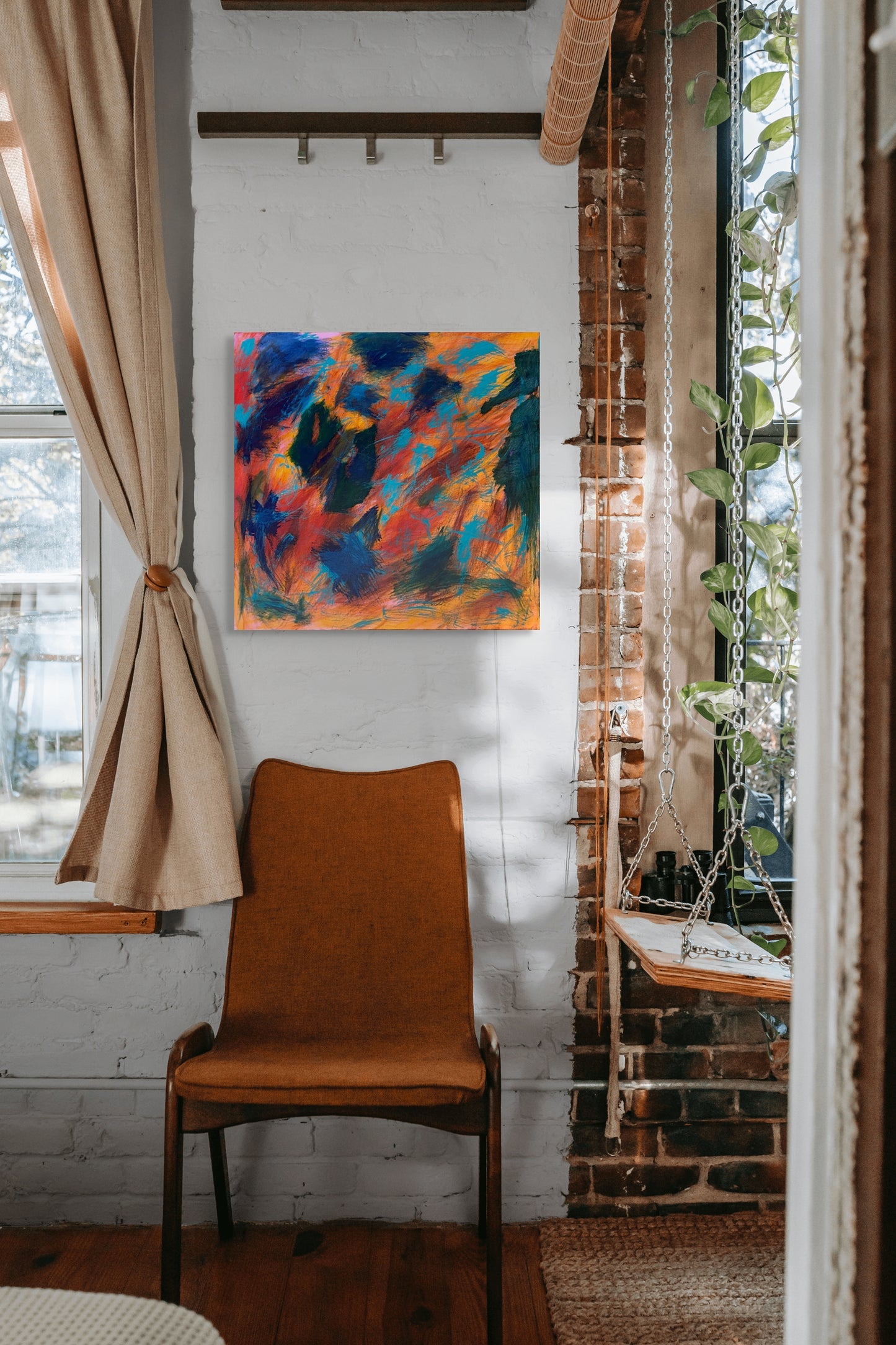 Colorful gestural abstract painting in a room setting.