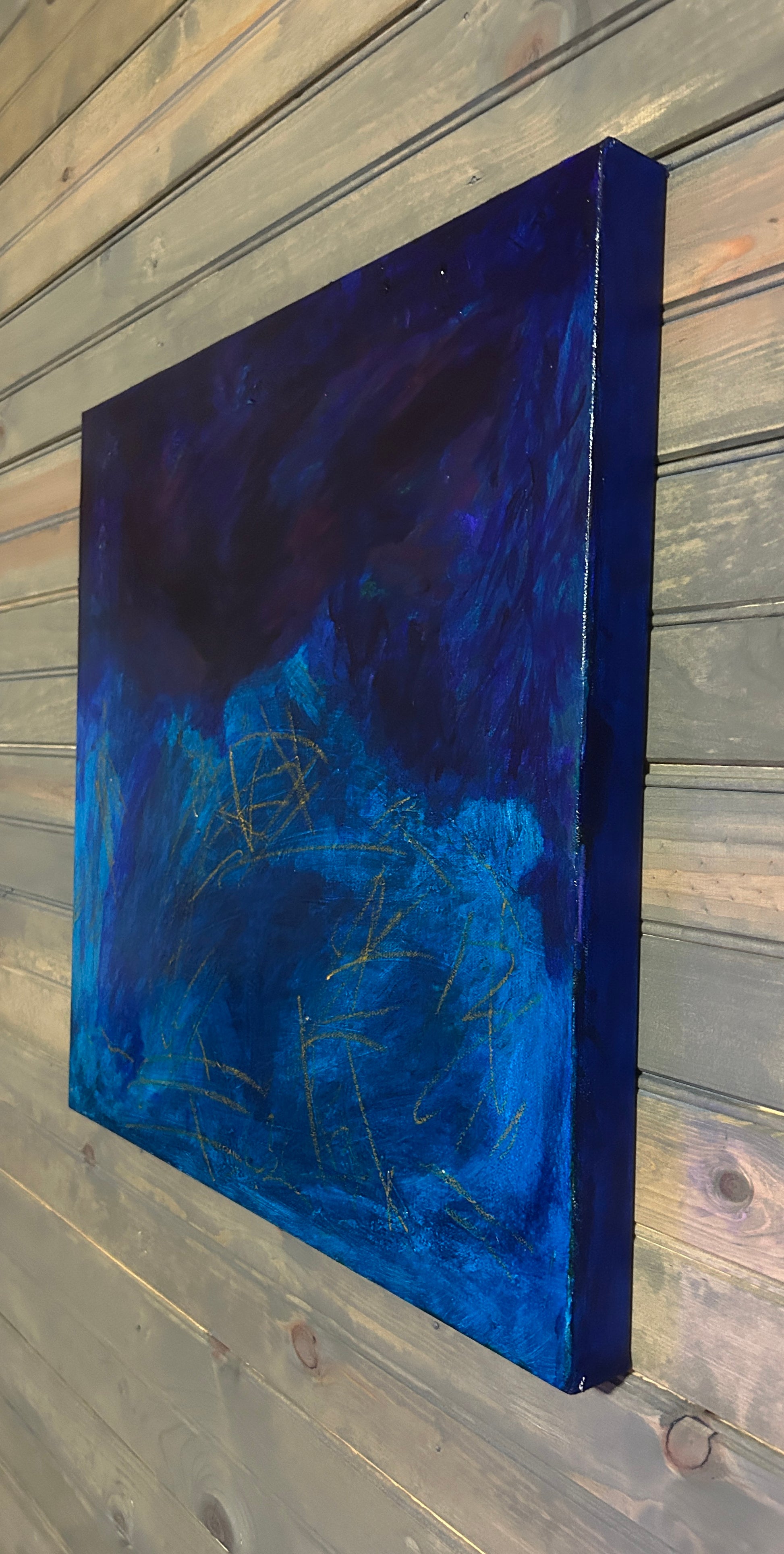 Abstract blue painting on a wooden surface