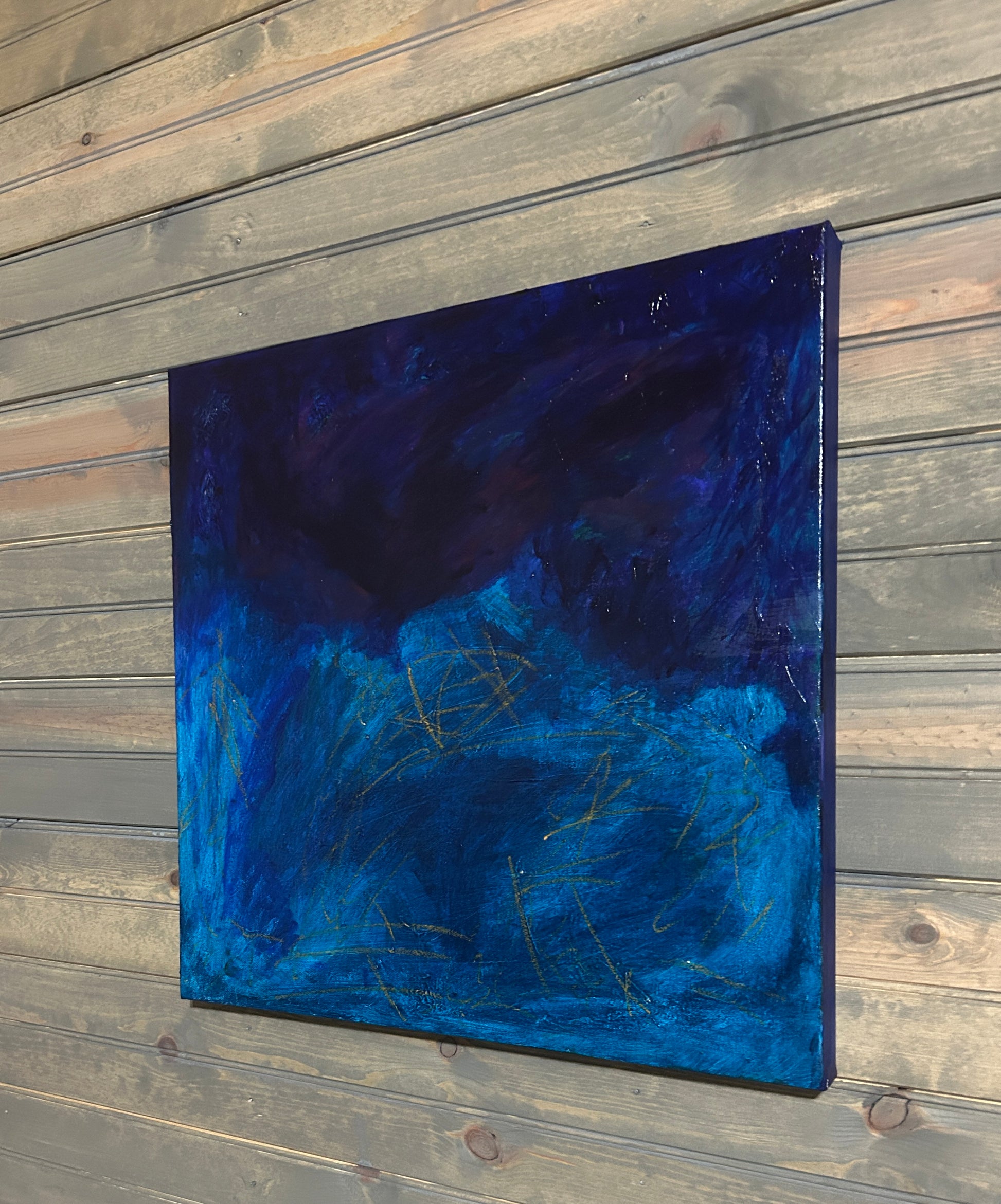 Abstract blue painting on a wooden wall